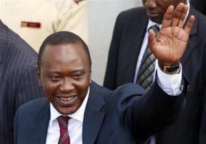 President-elect of Kenya Uhuru Kenyatta waves to his supporters in front of a church in his hometown Gatundu