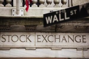 A street sign for Wall Street hangs in front of the New York Stock Exchange