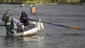 A woman rows her boat on the Egyptian Nile River in Cairo