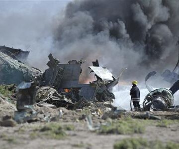 AMISOM firefighter attempts to extinguish fire at site of an airplane crash in Mogadishu Military plane bursts into flames at Mogadishu airport