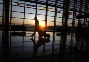 A passenger walks in Ronald Reagan airport as the sun rises in Washington