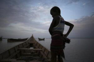 A Dassanach boy stands on a boat by the shore of a fishing camp near the Omo Delta in the north of Lake Turkana close to the town of Ileret and near the Kenyan-Ethiopian border in northern Kenya September 19, 2014. REUTERS/Goran Tomasevic