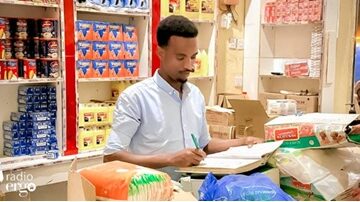 Adado- Shobkeeper- checks debt book Credit crunch faces drought-stricken pastoralist households in Adado