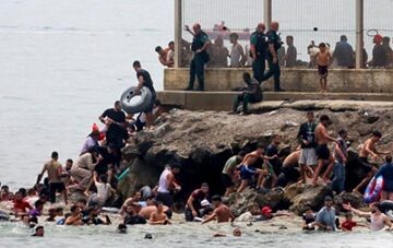 Massive migrant influx -Spain Hundreds of Migrants Reach Spain’s Ceuta Enclave in Dramatic Sea Crossing